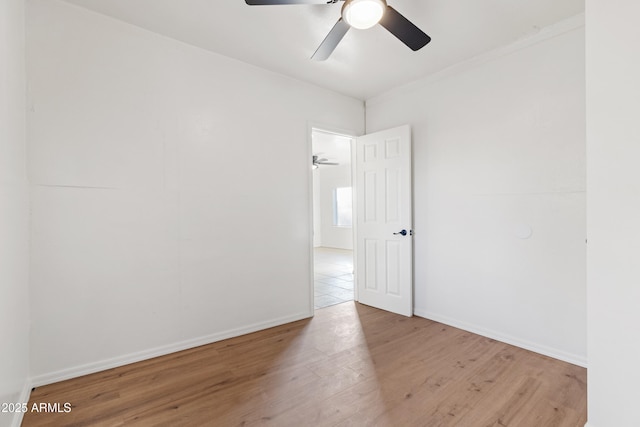 empty room with ceiling fan and light wood-type flooring