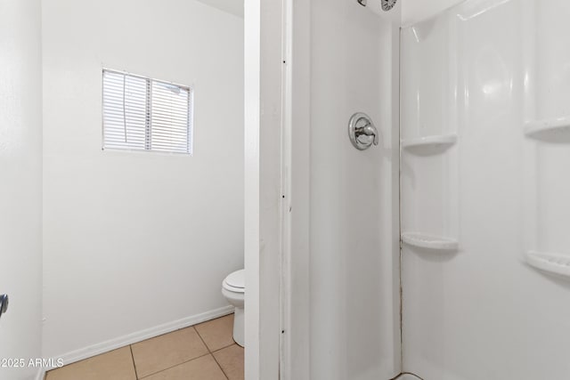 bathroom with tile patterned flooring, toilet, and walk in shower