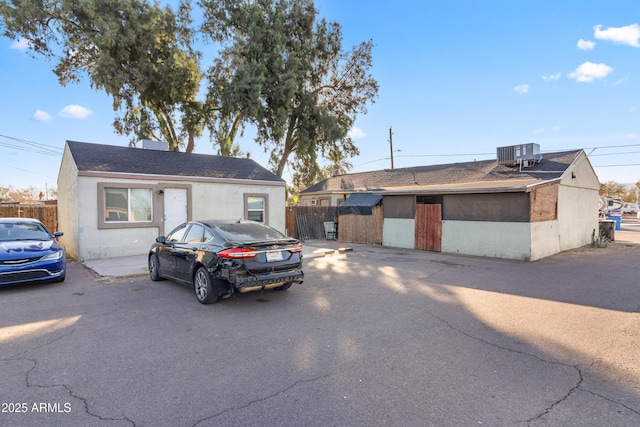 ranch-style home featuring cooling unit