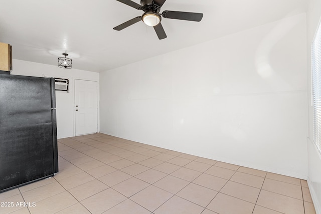 spare room featuring ceiling fan and light tile patterned floors