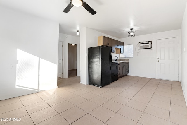 kitchen with black refrigerator, a wall mounted AC, ceiling fan, and light tile patterned floors