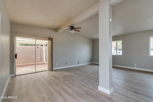 unfurnished living room featuring vaulted ceiling with beams, a textured ceiling, light hardwood / wood-style flooring, and ceiling fan