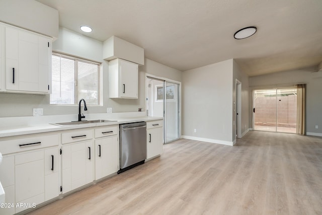 kitchen featuring white cabinetry, dishwasher, sink, light hardwood / wood-style floors, and a textured ceiling