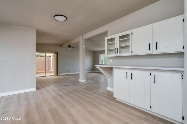 kitchen featuring white cabinets, light hardwood / wood-style flooring, and ceiling fan