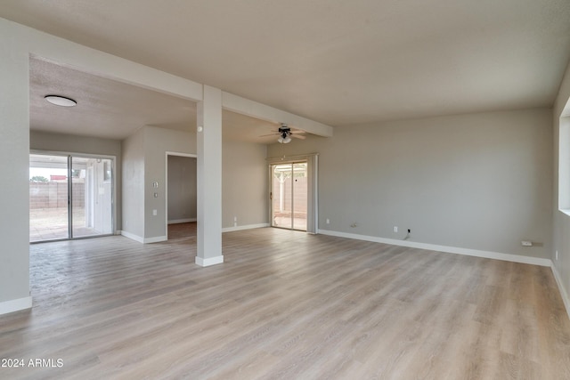 spare room with ceiling fan and light wood-type flooring