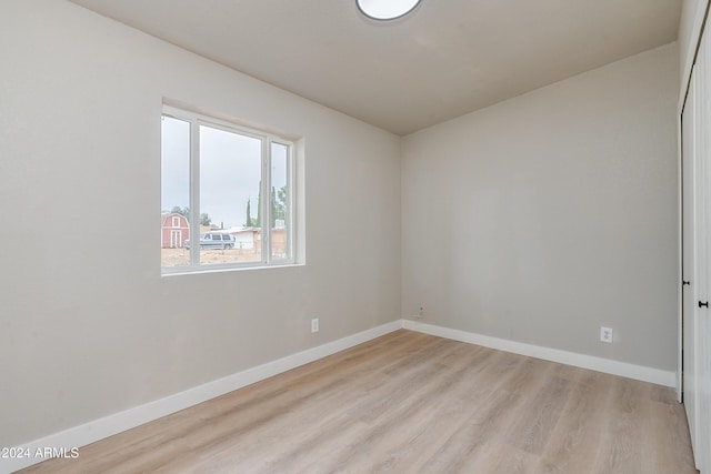 spare room featuring light hardwood / wood-style floors