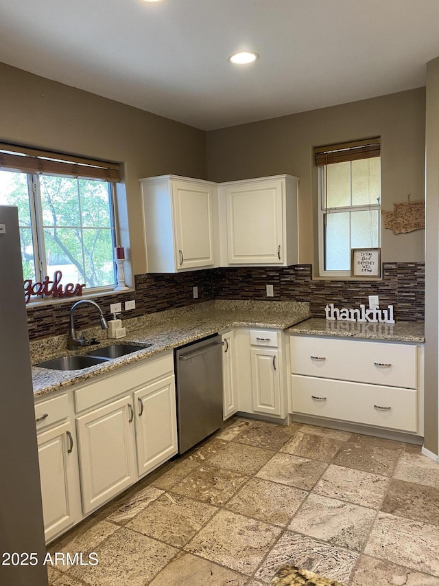 14575 W Mountain View Blvd Unit 711, Surprise, AZ 85374 - kitchen featuring stainless steel dishwasher, a sink, decorative backsplash, white cabinetry, and recessed lighting