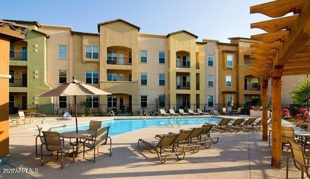 14575 W Mountain View Blvd Unit 711, Surprise, AZ 85374 - community pool featuring a patio and fence