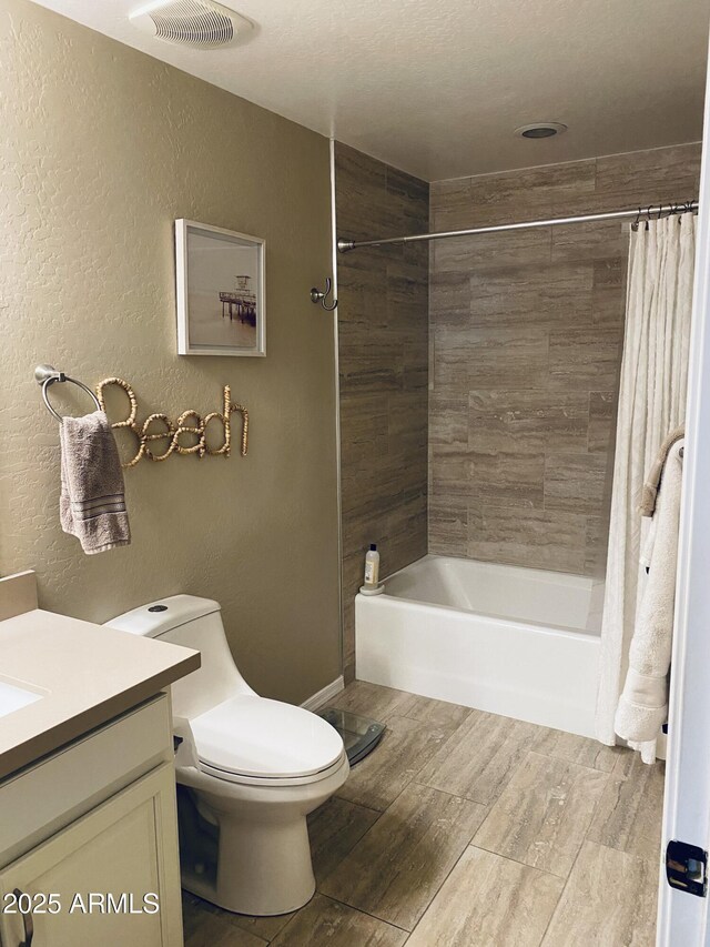 14575 W Mountain View Blvd Unit 711, Surprise, AZ 85374 - bathroom with wood finished floors, vanity, a textured wall, shower / bath combination with curtain, and toilet