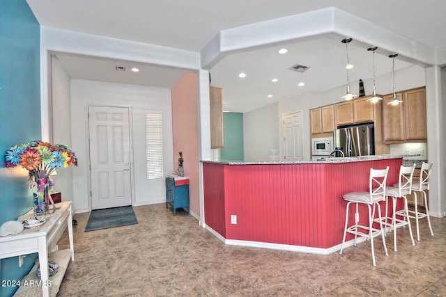 kitchen featuring hanging light fixtures, a kitchen breakfast bar, stainless steel refrigerator with ice dispenser, kitchen peninsula, and white microwave