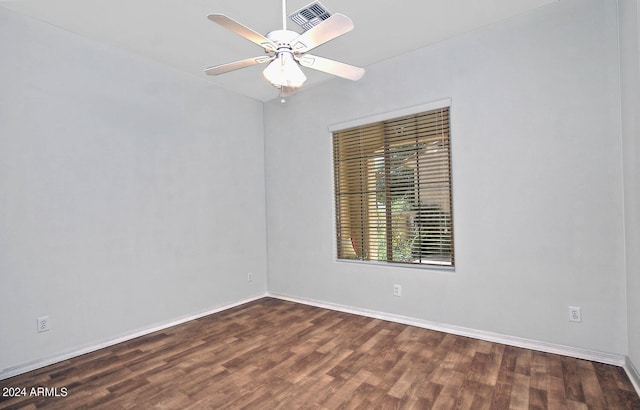 empty room with dark hardwood / wood-style floors and ceiling fan