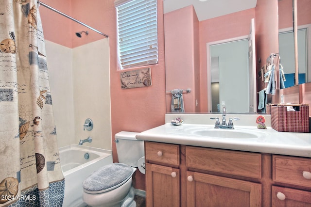 full bathroom with shower / tub combo with curtain, vanity, and toilet