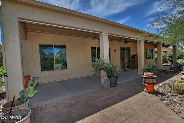 back of house with ceiling fan and a patio