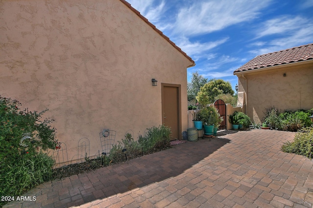 view of property exterior with a patio area