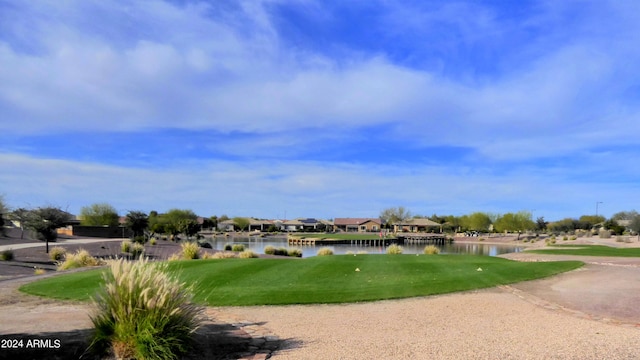 view of property's community featuring a water view and a yard