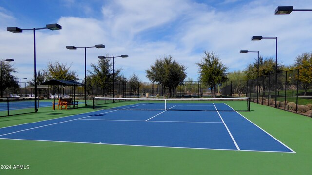 view of tennis court featuring basketball court