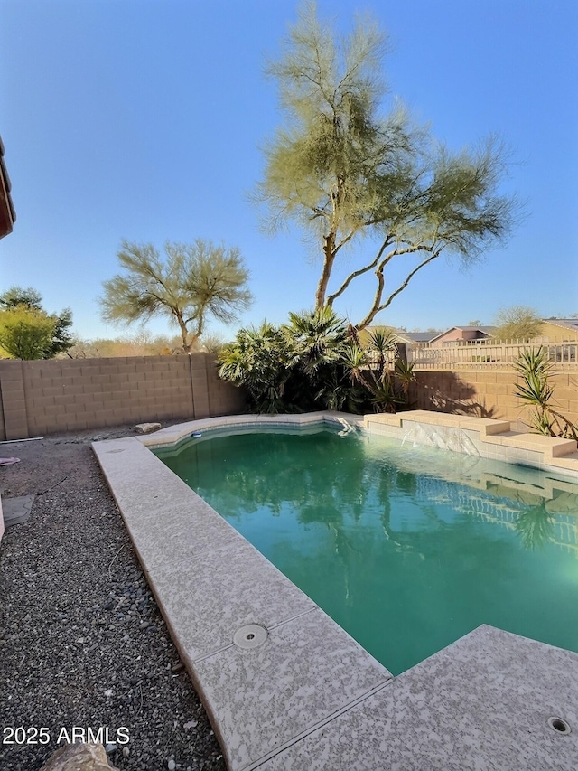 view of swimming pool with a fenced backyard and a fenced in pool