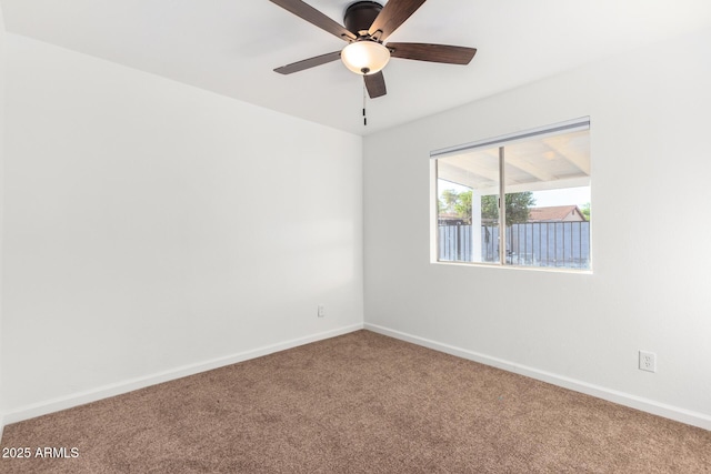 spare room featuring carpet, a ceiling fan, and baseboards