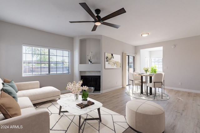 living room with ceiling fan, light hardwood / wood-style flooring, and plenty of natural light