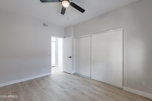 unfurnished bedroom featuring a closet, ceiling fan, and light hardwood / wood-style flooring