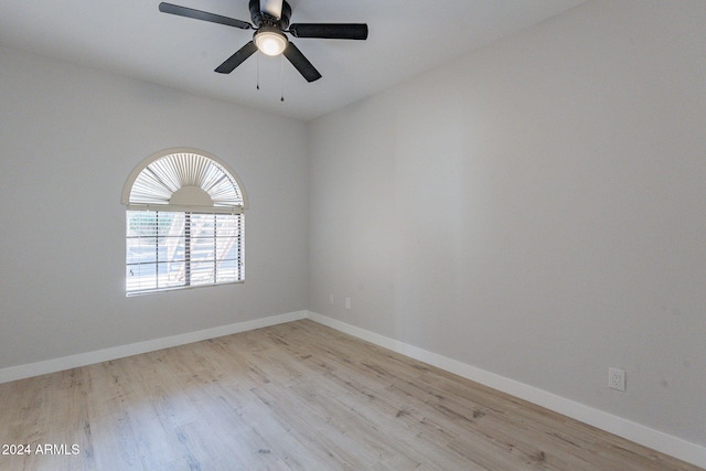 spare room featuring light hardwood / wood-style floors and ceiling fan