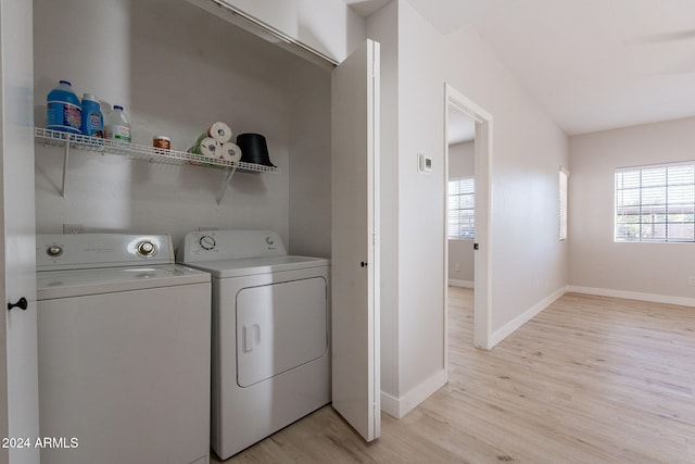 clothes washing area featuring separate washer and dryer and light wood-type flooring