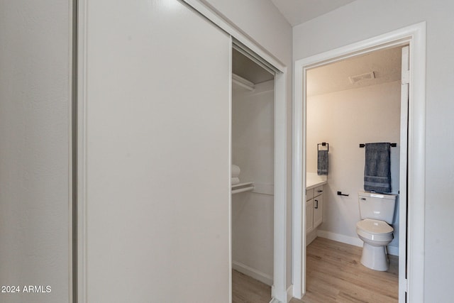 bathroom with vanity, hardwood / wood-style floors, and toilet