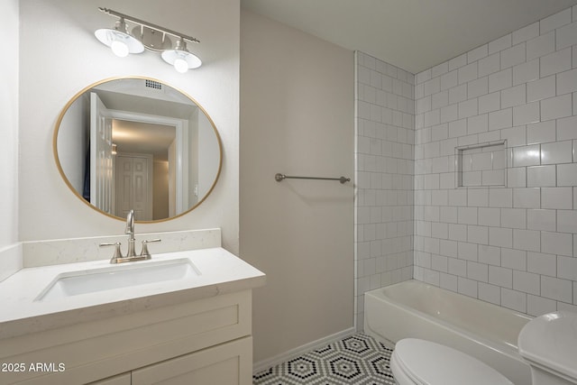 bathroom featuring shower / bathtub combination, tile patterned flooring, toilet, vanity, and baseboards