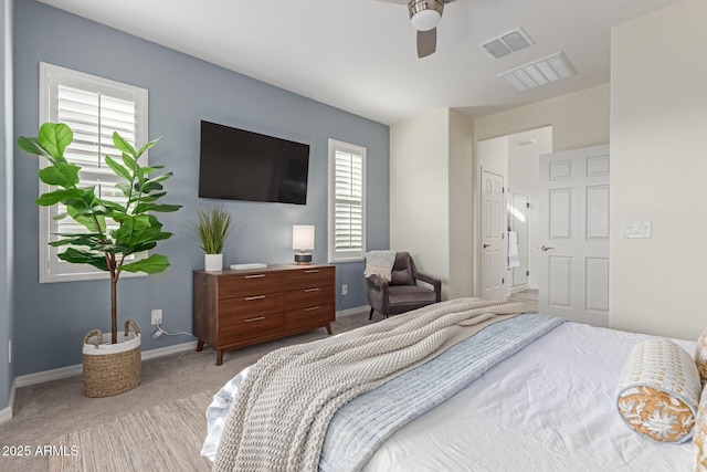 carpeted bedroom featuring multiple windows and ceiling fan