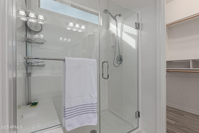 bathroom featuring hardwood / wood-style flooring and an enclosed shower