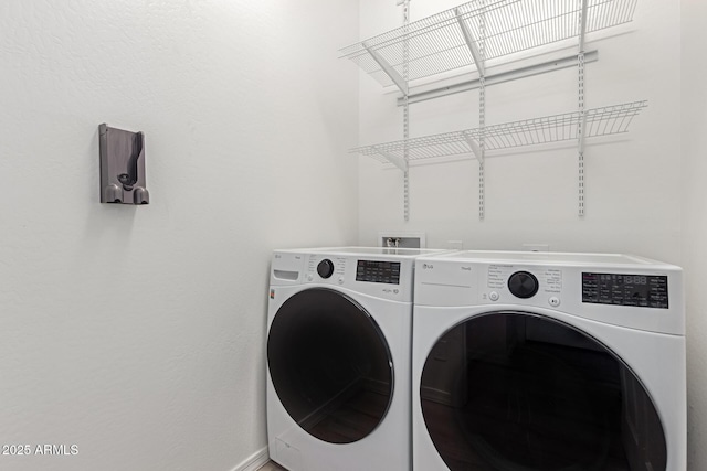 washroom featuring washer and clothes dryer