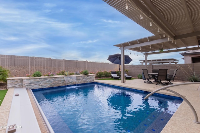 view of swimming pool with pool water feature and a patio