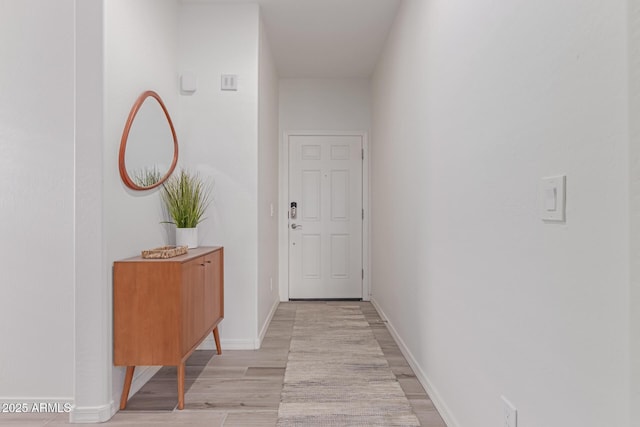 corridor with light hardwood / wood-style floors