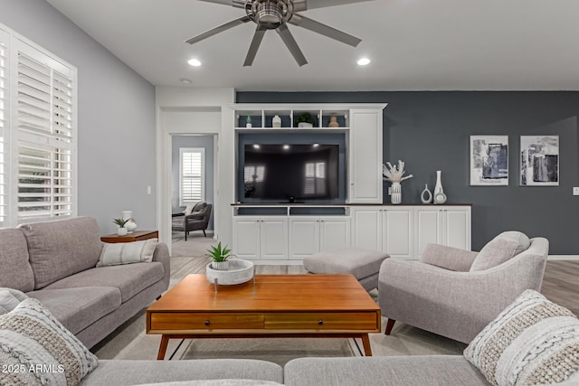 living room with ceiling fan and light hardwood / wood-style flooring