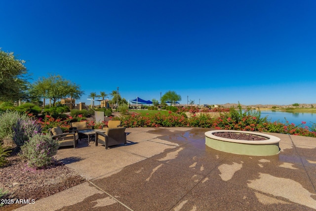 view of patio with an outdoor living space and a water view