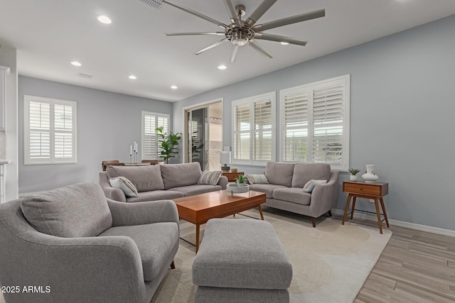 living room with ceiling fan and light wood-type flooring