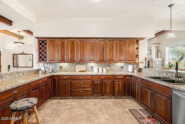 kitchen with a sink, light stone counters, tasteful backsplash, and dishwasher