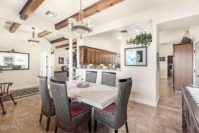 dining room featuring light tile patterned floors, baseboards, a chandelier, and visible vents