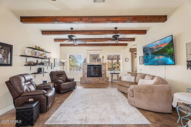 living area with beam ceiling, a stone fireplace, a ceiling fan, baseboards, and visible vents