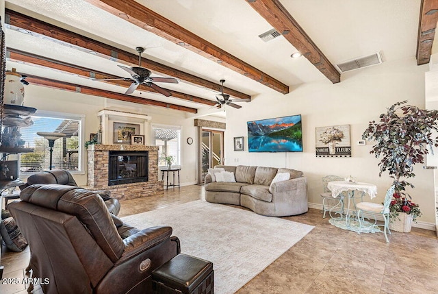 living room with a healthy amount of sunlight, baseboards, and visible vents