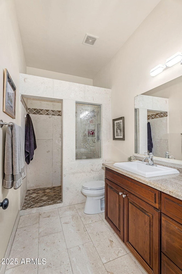 full bathroom with visible vents, a walk in shower, toilet, and vanity