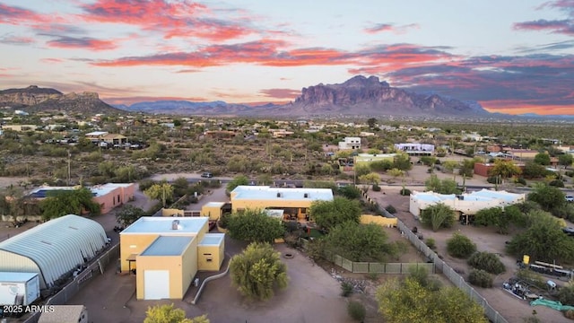 aerial view at dusk featuring a mountain view