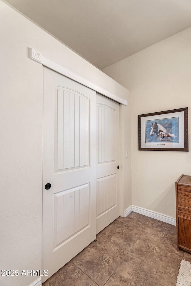 unfurnished bedroom with baseboards and a closet