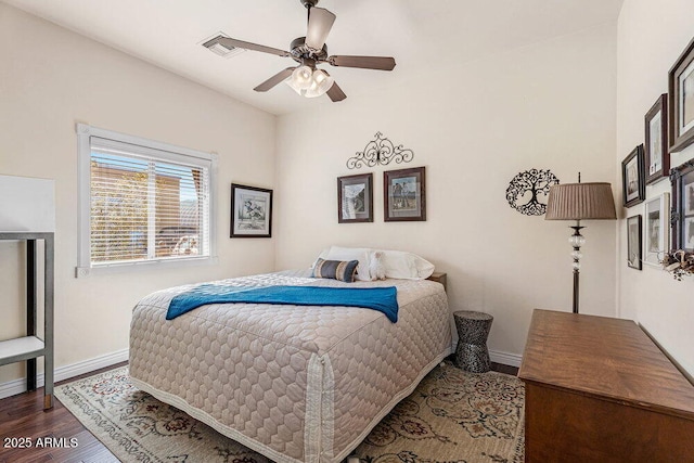bedroom with baseboards, ceiling fan, and wood finished floors