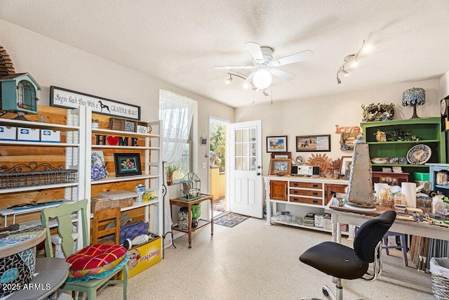 office space with a ceiling fan, a textured ceiling, and track lighting