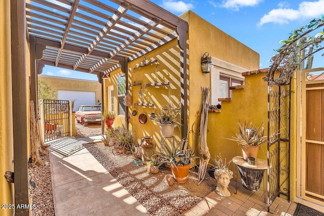 view of patio featuring a pergola and a gate