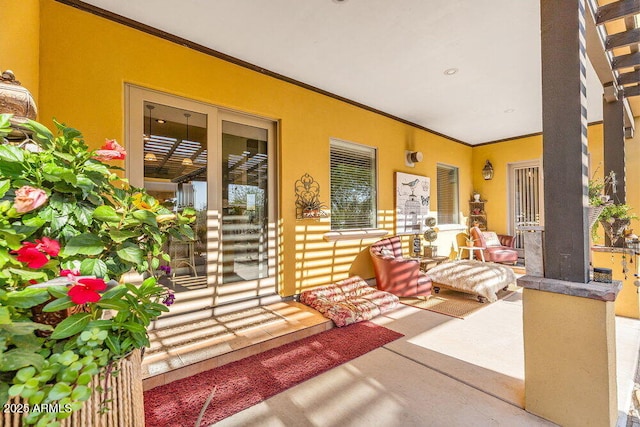 property entrance with covered porch and stucco siding