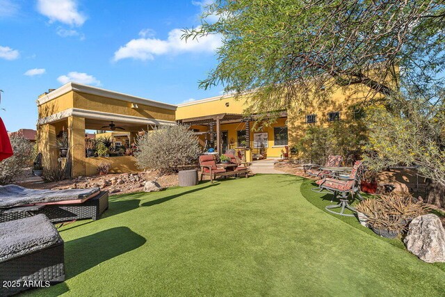 back of house featuring a patio, a ceiling fan, and stucco siding