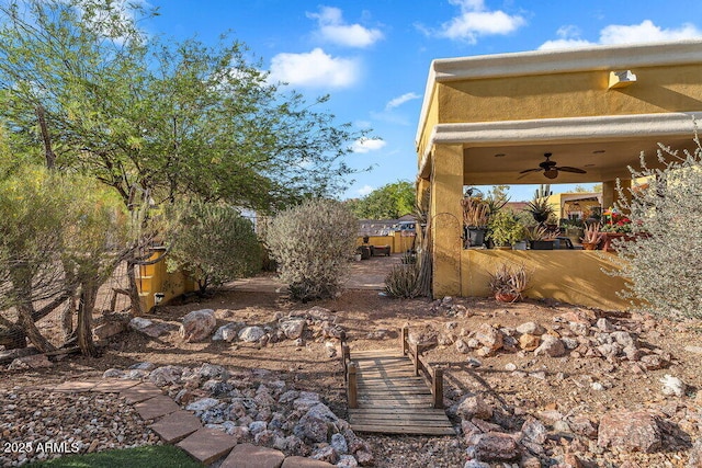 view of yard featuring a ceiling fan and fence private yard