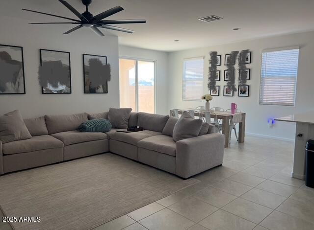 living room with ceiling fan and light tile patterned flooring